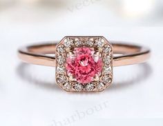 an engagement ring with a pink diamond in the center