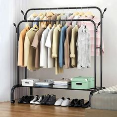 an iron rack with clothes and shoes on it