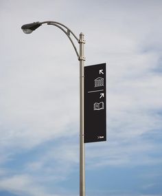 a street light pole with a sign on it