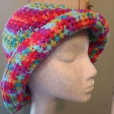 Fresh from my Central Wisconsin Studio, and hand crocheted by me. Bright and fun hippie bucket hat in tutti fruity ccors is a size large 24" and 7.5" deep.  Brim is 3" and can be worn down, flipped up, or rolled. Perfect for summer fun. Washable cold, dry low temp or hang dry. Please measure your head before ordering. Adjustable Multicolor Whimsical Crochet Hat, Hippie Multicolor Spring Hat, Multicolor Hand-knitted Bohemian Crochet Hat, Handmade Pink Bohemian Bucket Hat, Handmade Bohemian Pink Bucket Hat, Multicolor Crochet Wide Brim Sun Hat, Multicolor Bohemian Crochet Hat For Festivals, Funky Handmade Beach Hats, Bohemian Multicolor Crochet Hat For Festival