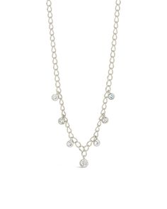 Add a touch of sparkle and a dash of pizzazz to any outfit with this shimmering Sydney Necklace! With a delicate chain and CZ charms, this dainty piece is sure to turn heads - no matter where you go. Materials: 14K gold or rhodium plated brass, cubic zirconia Features: Measures 16" with 2" extender, 0.25"-0.3" charms, 3-4mm CZ stones, 3.5mm chain width, Lead & Nickel free, lobster clasp Delicate Diamond Charm Necklace With Adjustable Chain, Dainty Diamond Chain Necklace With Adjustable Chain, Dainty Cubic Zirconia Cable Chain Necklace, Delicate Cubic Zirconia Charm Necklace With Adjustable Chain, Silver Chain Dangle Charm Necklaces, Dainty Chain Link Charm Necklace With Adjustable Chain, Silver Diamond Charm Necklace With Delicate Chain, Delicate Dangle Charm Necklaces With Adjustable Chain, Dainty Cubic Zirconia Chain Necklace