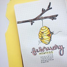 a notepad with a drawing of a beehive hanging from a branch