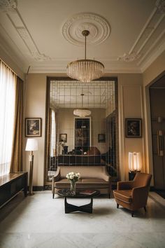 a living room filled with furniture and a chandelier