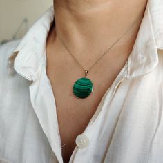 ITEM DESCRIPTION: >>The pendant is made from Solid 14K Yellow Gold. Gemstone used is absolutely natural and ethically sourced. >>Natural Flat cut Malachite in round shape with bezel setting are studded on it with utmost precision. >>This is a minimalist design and is absolutely hassle-free and everyday jewelry. ✓ Gem: Malachite ✓ Gem size: 20x20 mm round ✓ Gem weight: 17.65 carats ✓ Gold purity: 14K (58.33% approx.) ✓ Gold weight: 0.65 grams ✓ Gross weight: 4.18 grams The Gold purity is guarante Fine Jewelry Malachite Round Jewelry, Fine Jewelry With Round Malachite, Round Malachite Fine Jewelry, Oval Malachite Jewelry In Yellow Gold, Malachite Round Gemstone Jewelry, Round Malachite Gemstone Jewelry, Green 14k Gold Necklace With Polished Finish, 14k Gold Green Necklace With Polished Finish, Malachite Necklace