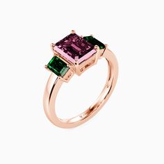 a pink and green ring with two emeralds on the sides, set in 18k rose gold