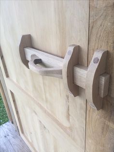 a wooden door with two handles on it