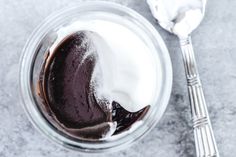 a glass bowl filled with chocolate pudding and whipped cream