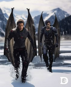 two men with wings walking in the snow