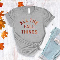 All The Fall Things in a modern font graphic on front in cream or multi Fall colors. Youth Sizes S-XL (unisex sizing) Toddler Sizes 2T, 3T, 4T To view All The Fall Things Adult T-shirts click here.To view All The Fall Things Baby Bodysuit click here.Bella + Canvas4.2 oz. Airlume combed and ring-spun cottonPre-shrunkFor a more relaxed fit, size up! Fall Graphic Print T-shirt, Fall Soft-washed Tri-blend T-shirt, Soft-washed Tri-blend Fall T-shirt, Tri-blend Graphic Tee For Fall, Fall Graphic Tee Soft-washed, Fall Slogan T-shirt Relaxed Fit, Fall Slogan T-shirt With Relaxed Fit, Fall Graphic T-shirt With Slogan, Fall Graphic Tee With Slogan