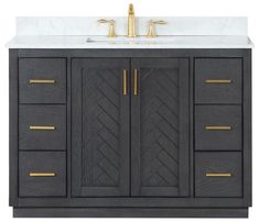 a bathroom vanity with marble top and gold handles on it's doors, along with two faucets