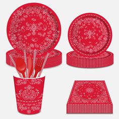 a set of red dinnerware and placemats