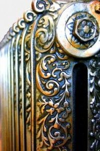 an ornately decorated metal door is shown in this close up photo, with the key hole open