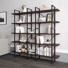 a living room with a white couch and bookshelf on the wall in front of it