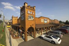 an aerial view of a store with cars parked in front