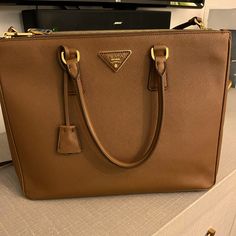 Currently Selling For $4700 On Prada Website But This Color Is Completely Sold Out. Double Straps, Can Be Worn As Crossbody With Removable Strap Or Carry With The Double Candles. I’ve Used Twice For Ipad Air And Legal Pad. No Exterior Scratches Except For The Corners Which Have Minor Wear. Never Used Interior Pockets And There Is Absolutely No Wear To The Inside Of The Bag. It Has Been Stored Stuffed With Pillowcase So The Shape Is Still Near Perfect And Stiff. Hasn’t Even Been Broken In Yet. Pl High-end Epsom Leather Bag For Everyday Luxury, Elegant Epsom Leather Shoulder Bag For Everyday Luxury, High-end Epsom Leather Shoulder Bag For Everyday Luxury, Epsom Leather Bags For Everyday Luxury, Elegant Epsom Leather Bag For Everyday Luxury, Gold Epsom Leather Travel Bag, Elegant Shoulder Bag With Branded Hardware And Epsom Leather, Elegant Epsom Leather Shoulder Bag With Branded Hardware, Gold Epsom Leather Bag For Everyday Luxury