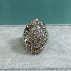 "LARGE and IN CHARGE is really the best way to describe this diamond cluster cocktail ring. \"Stunning\" works too! It has 68 diamonds to equal a whopping 1.14 carats of diamonds, prong set in 10K yellow gold. The head of this ring measures 1\" Long x 3/4\" Wide. Diamond information: - 24 round diamonds at 1.6mm each = .66 CTW - 44 baguette cut diamonds are 1.8x1.5mm = .48 CTW - Total carat weight of the ring is 1.14 carats - All diamonds are I in color and have a clarity of I2-I3 Size is 6.25 S Antique Jewelry Rings, Diamond Cocktail Ring, Diamond Cocktail Rings, Ring Pictures, Baguette Cut Diamond, Baguette Cut, Diamond Cluster, Cocktail Ring, Cocktail Rings