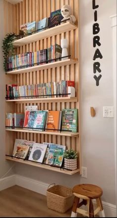 a bookshelf filled with lots of books next to a wall