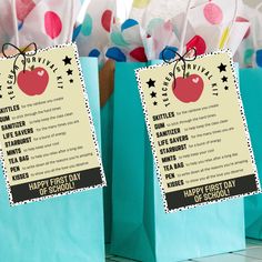 two paper bags with happy first day messages on them