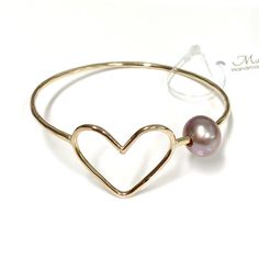 This listing is for 1 adult bangle. Simple heart bangle is make with fine metals round wire and genuine pink Edison pearl. Bangle is hand- formed, hammered into a scalloped design then polished for a stunning texture and shine. It looks great worn alone or stack with other shell and charm bangles to create a chic, fun beachy look. Pink pearl is measured 10-11mmin size. Each bangle is custom made to order so can not be return or exchange for that reason. I can custom made your bangle with any cha Heart-shaped Bangle For Valentine's Day, Gold Heart-shaped Bangle, Valentine Jewelry, Cone Shell, Scalloped Design, Charm Bangles, Edison Pearls, Pearl Bangle, Jewelry Safe