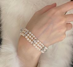 Indulge in timeless elegance with our vintage-inspired pearl bracelet set. This stunning piece features three strands of Swarovski pearls, beautifully accented by gold plating for a touch of luxury. The delicate clover moissanite charm adds a hint of sparkle, making this bracelet perfect for layering with your favorite accessories. Whether you're treating yourself or looking for the perfect Christmas gift, this versatile bracelet set is designed to enhance any outfit with its classic beauty and Elegant Beaded Bracelets With Pearl Charm For Party, Elegant Pearl Bracelet With Charm For Parties, Elegant Pearl Charm Bracelet For Parties, Elegant Round Pearl Bracelet For Parties, Elegant Pearl Drop Beaded Bracelets For Anniversary, Elegant Pearl Embellished Bracelets As Gifts, Elegant Pearl Bracelet For Party, Elegant Pearl Embellished Bracelet As Gift, Elegant Pearl Embellished Bracelet Gift