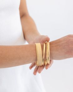 Our Laudomia Bangle Set makes accessorizing the easiest part of your day. Hand-selected by Susan to create the perfect mix-and-matched set, these bangles effortlessly complement each other. Stack them with other bangles, wear them as a package deal, or only wear a couple at a time. No matter how you style your Laudomia Bangles, you can be sure they'll add that special something to your look. Elegant Gold Stackable Wrap Bracelet, Elegant Gold Double Band Cuff Bracelet, Elegant Double Band Gold Cuff Bracelet, Gold Stackable Wrap Bracelet, Elegant Stackable Bangle Wrap Bracelet, Modern Stackable Bangle Bracelets, Elegant Flexible Bangle For Everyday Wear, Elegant Double Band Bracelet With Strap, Elegant Double Band Bracelet Jewelry