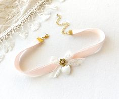 This romantic choker necklace is handmade with a soft blush pink double sided velvet ribbon. It features a vintage lace ribbon bow, pearl beaded jewel, and a beautiful vintage mother of pearl heart charm. A lovely gift for women who love to wear unique jewelry.  See last photos showing coordinating necklaces! This necklace is also available in blue, white and black velvet... sold separately in the Rosy Posy Designs shop. * Size ~ Adjustable length 12 - 15 inches with extender chain  Please check Ribbon Choker Necklace For Weddings, Cute Bow Jewelry For Wedding, Feminine Adjustable Choker For Wedding, Pink Ribbon Wedding Jewelry, Elegant Wedding Choker For Valentine's Day, Feminine Adjustable Ribbon Jewelry, Adjustable Wedding Choker For Valentine's Day, Lace Ribbon Bow, Rosy Posy