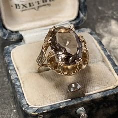 1970s vintage 9ct yellow gold smoky quartz ring. Stunning oval cut stone to a decorative scalloped style mount with textured detail to the gold shoulders typical of its era. In amazing condition having been cleaned and polished. Metal; 9ct yellow gold Hallmark; Birmingham, 375 Date; 1976 Stone; smoky quartz Stone size; 13 mm x 10 mm Carat weight; 4.13ct estimated Rise from finger; 8mm Condition; as above Weight; 3.8 grams Ring size; K.5 (UK) Size 5 3/8 (US)  Antique box is not included Will come Luxury Vintage Gold Crystal Ring, Luxury Antique Bronze Rings, Smoky Quartz Ring, Antique Boxes, Wedding Vibes, Quartz Ring, Gold Texture, Quartz Stone, Cocktail Ring