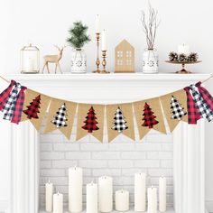 a mantle with candles and christmas decorations on it in front of a white brick fireplace