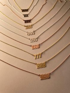 "Angel Number Necklace, 111, 222, 333, 444, 555, 666, 777, 888, 999, 000, Angel Numbers, Devil Necklace, Law of Attraction, Numerology Gift Angel Numbers meanings are as follow; 111: is a sign of divine support. You're moving into a new phase of life and self-actualization. It's paramount that you trust yourself and your guides. 222: is symbolic of a coming together of some sort--like a reunion or a new union. Seeing 2s is a message to open yourself more deeply to love and camaraderie. 333: is a Gold Jewelry For Anniversary And New Year, Gold Jewelry For New Year's Anniversary, Elegant Silver Jewelry For New Year, 000 Angel Numbers, Necklace 777, 111 Necklace, Angel Number Jewelry Aesthetic, Angel Numbers Jewelry, Angle Number Necklaces