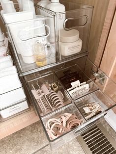 an organized drawer in the corner of a bathroom