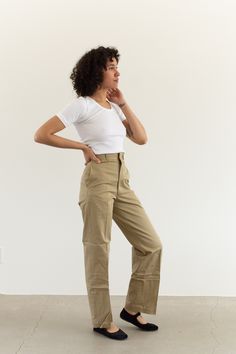 "These military khaki twill wide leg pants are the perfect addition to any wardrobe. They feature the following: zipper fly, straight wide leg, side pockets, back pockets, belt loops. Material: 100% Twill Cotton | Made in the USA in the 60s Condition: Excellent. Deadstock. Unwashed. Measurements: 24\" Waist Button / 34\" Hips / 13\" Rise / 11.5\" Thigh Flat / 31\" Inseam 25\" Waist Metal Tab / 35\" Hips / 13\" Rise / 11.5\" Thigh Flat / 31\" Inseam 26\" Waist Button / 35-36\" Hips / 13\" Rise / Military Style High Waist Khaki Pants, Military High Waist Khaki Pants, Khaki Military Work Pants With Belt Loops, Beige High-waisted Cotton Chinos, Relaxed Fit Military Khaki Bottoms, Sailor Pants, Workwear Trousers, Wide Leg Cropped Pants, Pantalon Large