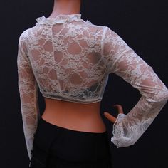 "Cream lace top is a feminine staple for all seasons. Slip on this cropped cover up to give a chic cozy touch to everything from skirts to sundress, jeans, and shorts. This top has long sleeves and a tie fastening the front. 100% lace. Mannequin is 177cm/ 5'10\" and is wearing a size small SIZE XS (US S 0-2, UK 6-8, Italian 36-38, French 32-34) Bust: fits bust around 32-33 Waist: fits waist around 24-25 Hips: fits hips around 35-36 SIZE S (US S 4-6, UK 10-12, Italian 40-42, French 36-38) Bust: f Cream Lace Top, Plus Size Top, Cream Lace, Yoga Tops, Long Blouse, Wrap Top, All Seasons, Sundress, Lace Top