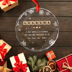 a glass ornament that says grandma is only worth 11 in scrabble but you are priceless to us