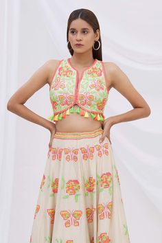 Ivory crop top with all-over multi-color floral-butterfly motif resham-sequin work and tassel hem.
Component: 1
Embroidered
Neckline: Round
Sleeve Length: Sleeveless
Fabric: Dupion Silk
Color: White
Split neck
Tassel hem
Note: Lehenga worn by the model is not for sale - Aza Fashions Sleeveless Multicolor Embroidered Summer Sets, Sleeveless Sets With Multicolor Embroidery For Summer, Sleeveless Summer Sets With Multicolor Embroidery, Multicolor Floral Embroidered Sleeveless Set, Multicolor Sleeveless Sets With Floral Embroidery, Embellished Multicolor Choli, Embroidered Sleeveless Summer Choli, Summer Sleeveless Embroidered Choli, Summer Multicolor Embroidered Sets