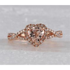 Revel in the radiance of masterful artistry with this enchanting 10K Rose Gold Heart Morganite Diamond Fashion Ring, a piece that embodies romance and sophistication. At the heart of this captivating ring lies a beautifully prong-set, heart-shaped morganite, radiating a delicate blush hue that captures the essence of tender emotions. This exquisite morganite, weighing a substantial 1 carat, is cradled within a setting of 10K rose gold, enhancing its warmth and feminine allure.Surrounding the mor Luxury Rose Gold Diamond Ring For Valentine's Day, Rose Gold Heart Cut Ring For Wedding, 14k Rose Gold Heart Jewelry For Wedding, Wedding Heart Cut Rose Gold Heart Ring, Heart-shaped 14k Rose Gold Wedding Jewelry, Elegant Rose Gold Heart-shaped Diamond Ring, Rose Gold Rings With Heart-cut Rose Diamonds, Rose Cut Diamond Rings For Valentine's Anniversary, Rose Gold Heart Cut Rings With Rose Cut Diamonds