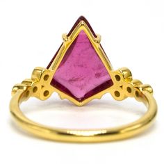 We're obsessed with this ring. Set in a warm, rich 18 karat yellow gold, this fantastic statement piece has an oversize cabochon cut rubellite (pink tourmaline) that's prong set and flanked on each side by four bezel set diamonds. The amount of whimsy in this ring is unmatched; the Barbie pink fancy cut center stone paired with diamonds that look like bubbles make this an incredible spring or summer piece! Metal: 18K Yellow Gold Main Stone: 1 Kite Cut Cabochon Pink Tourmaline (3.67 carats, 13.24 Yellow Gold Tourmaline Cabochon Ring, Luxury Tourmaline Cabochon Rings, Chevron Earrings, Chevron Bracelet, Chevron Necklace, Jewelry Appraisal, Vintage Wedding Band, Gemstone Engagement, Bezel Set Diamond