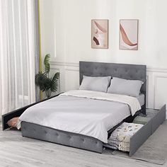 a bed that is sitting in the middle of a room with white walls and flooring