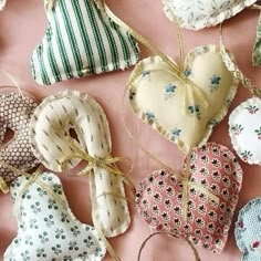 many different heart shaped ornaments on a pink surface