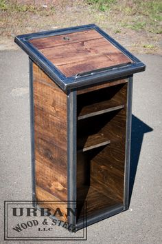 a wooden and metal box sitting on the ground