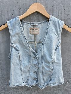 The Free People Tate Denim Vest is the perfect addition to your wardrobe! Its cropped design and v-neck style add a touch of edge, while the front button closure and adjustable buckle back provide functionality. Rock this versatile vest for a stylish, on-trend look. 100% Cotton Front Button Closure Adjustable Buckle Back Machine Wash Cold With Like Colors, Non-Chlorine Bleach Only, Tumble Dry Low, Iron Low, May Be dry Cleaned Shop More Colors Of The Tate Denim Vest Here! Cheap Denim Blue Vest With Buttons, Cheap Washed Sleeveless Vest, Cheap Fitted Distressed Denim Vest, Cheap Spring Denim Vest Top, Cheap Summer Utility Denim Vest, Women's Summer Denim Vest, Cheap Utility Denim Vest, Cheap Stretch Denim Vest, Cheap Casual Relaxed Fit Denim Vest