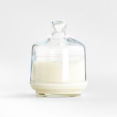 a glass jar filled with milk sitting on top of a table