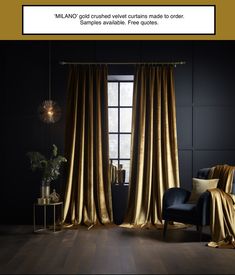 a living room with black walls and gold curtains