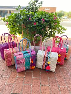 "This beautiful basket bag is made with recycled PVC, handwoven by Mexican artisans. Each bag is one of a kind with a unique design and color pattern. *Includes Pompom tassel *Rinsable *Durable *Fashionable *Light Weight *Eco- Friendly *Reusable Closes at top with four flaps and two magnetic buttons. *All bags are handmade, measurements will vary slightly. Length x Width x Height / Strap Drop Small Basket Bag: 10\" x 5\" x 8\"/ 8 inches" Mexican Plastic Woven Bags, Mexican Market Bag, Rectangular Multicolor Box Bag For Gifts, Multicolor Rectangular Box Bag, Multicolor Bags With Braided Handles As Gift, Multicolor Bags With Braided Handles For Gift, Multicolor Basket Bag As A Gift, Multicolor Basket Bag As Gift, Multicolor Basket Bag For Gift