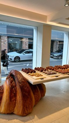 a large piece of bread sitting on top of a counter in front of a window