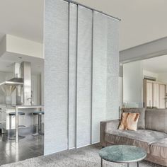 a living room filled with furniture and a sliding glass door