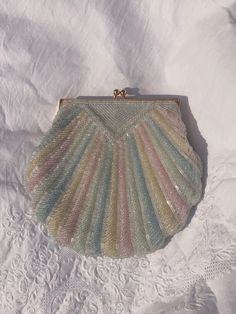 A beautiful rainbow of pastel color beaded shell bag. Hand beaded with iridescent beads in baby pink, blue, yellow, green and white colors.  <> Vintage reproduction & handmade <> Excellent condition <> Brass clasp closure  <> Fully lined  Measurements: Width 21 cm  Height 19 cm  ♡ RETURNS ♡ All items are FINAL SALE. Every item is rare and thoughtfully selected. Measurements, quality, material, and photos are all listed in descriptions of every item to ensure the item is being represented fully. Vintage items may have slight imperfections due to age and previous wear, please appreciate these items for their character :) ♡ Follow us ♡ Instagram: @heidi.vintage https://www.instagram.com/heidi.vintage  ♡ Check out our jewelry store on Etsy ♡ www.pinablue.com  Instagram: @thepinablue No Ordinary Girl, Beaded Shell, Estilo Grunge, Party Clutch, Vintage Rainbow, Baby Colors, Mode Ootd, Pretty Bags, Soft Baby