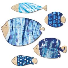 three wooden fish with blue and white designs on them