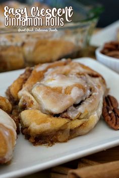 cinnamon rolls are sitting on a white plate