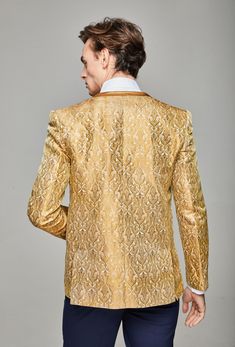 Traditional in an Untraditional World. The Aleatiqa Blazer is expertly crafted, using a method of wrapping wire upon silk thread that is electroplated with gold and woven into our blazer fabric. Creating an intricate yet elaborate, embroidered pattern smooth to touch that reflects light to shine brilliantly. Colour: White Gold Regular Fit Collarless Contrasting Trim Lined Ornate Metallic Embroidery Model is 183.5cm tall and wearing a size Medium Fabric Composition: Mixed Fibres Metallics Fashion, Embroidered Blazer, Collarless Blazer, Gold Suit, Blouse Man, Metallic Embroidery, Fashion Moodboard, Gold Blouse, Metal Fashion