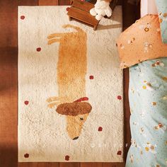 a child's bedroom with a rug that has a dog on it and a teddy bear